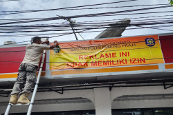 Tidak Berizin, Satpol PP Jogja Menyegel Empat Reklame Papan Nama Toko